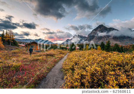 Wooden Naiset huts with rocky mountains in autumn Wooden Naiset huts with rocky mountains in autumn 62568611
