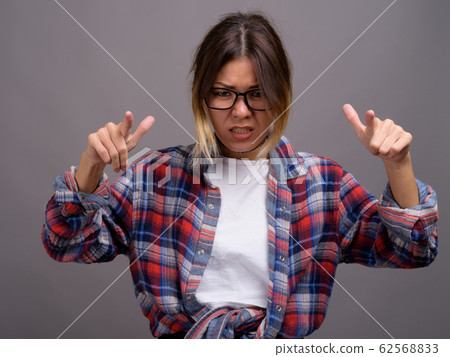 Young beautiful Kazakh woman against gray background Young beautiful Kazakh woman against gray background 62568833