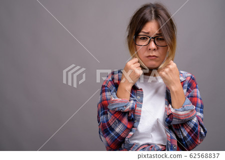 Young beautiful Kazakh woman against gray background Young beautiful Kazakh woman against gray background 62568837