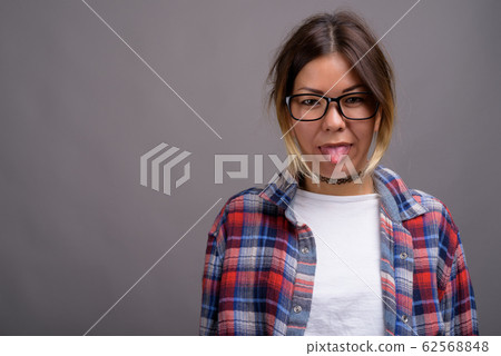 Young beautiful Kazakh woman against gray background Young beautiful Kazakh woman against gray background 62568848