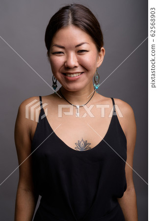 Young beautiful Kazakh woman against gray background 62568903