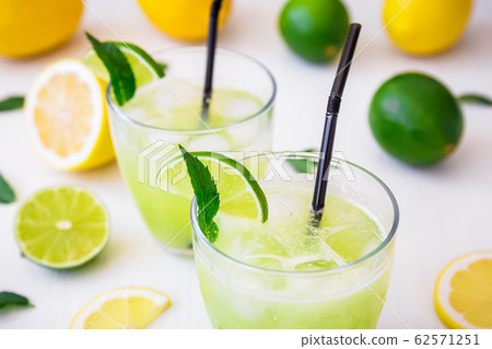 Citrus cold lemonade with limes, mint and lemons in glasses 62571251
