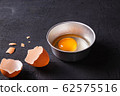 Raw eggs in a bowl and egg shell 62575516