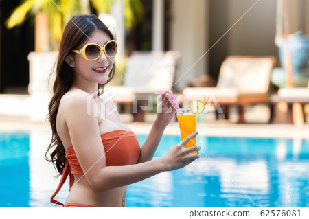 Sexy young asian woman in swimsuits in summer. Sexy young asian woman in swimsuits in summer. 62576081