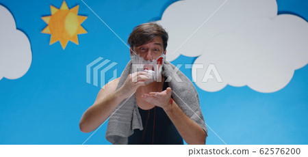 Man cutting his face while shaving 62576200