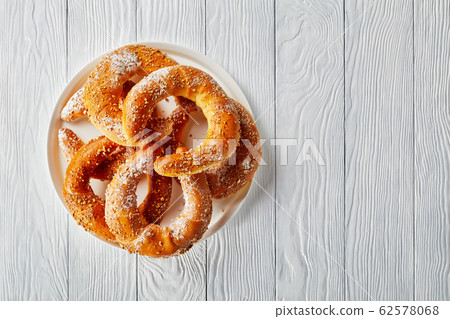 Sweet pastry rolls on a white wooden background 62578068
