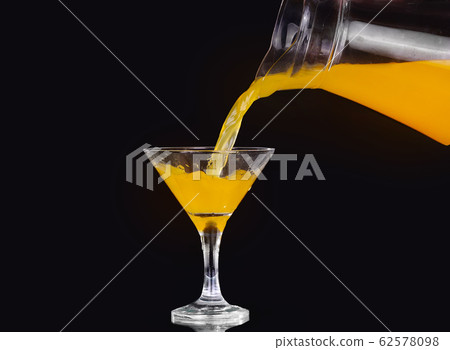 pouring orange juice into glass, Fresh pouring 62578098