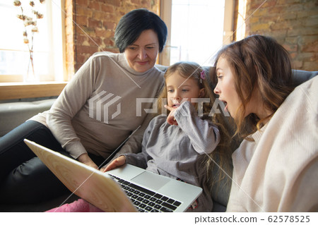 Happy loving family. Grandmother, mother and daughter spending time together Happy loving family. Grandmother, mother and daughter spending time together 62578525