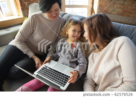 Happy loving family. Grandmother, mother and daughter spending time together Happy loving family. Grandmother, mother and daughter spending time together 62578526