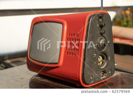 Old retro TV set reciever on wooden table 62579569