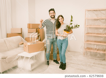 Caucasian young couple happy to moving in to new apartment. Caucasian young couple happy to moving in to new apartment. 62579608