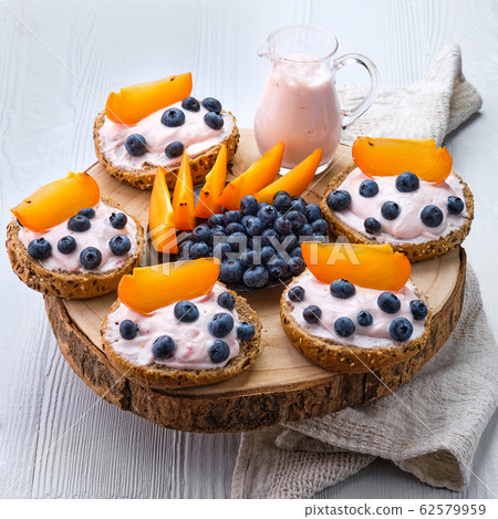 Sweet buns with soft cheese, blueberry Sweet buns with soft cheese, blueberry 62579959