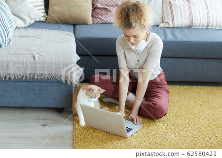Woman typing on laptop Woman typing on laptop 62580421