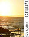 Standing at sunset 62588278