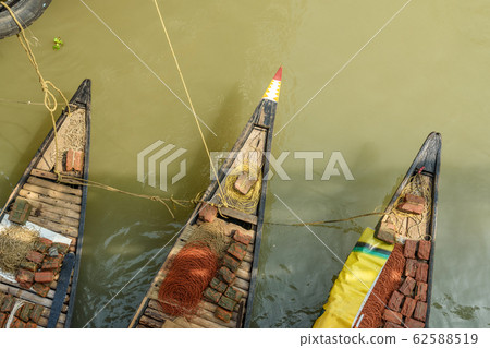 Traditional wooden fishing boat in river Hooghly Traditional wooden fishing boat in river Hooghly 62588519