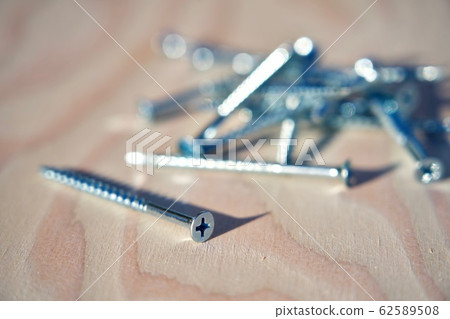 Screws on wooden board Screws on wooden board 62589508