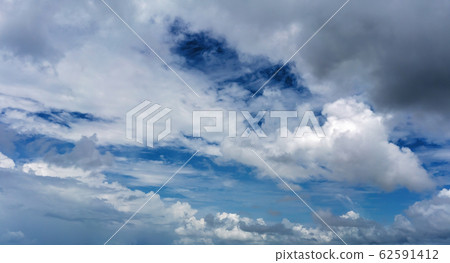 Fluffy Clouds In A Deep Blue Sky 62591412