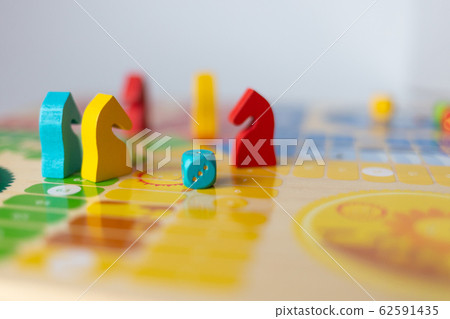 colorful play figurine with dice, ludo board game, blured 62591435