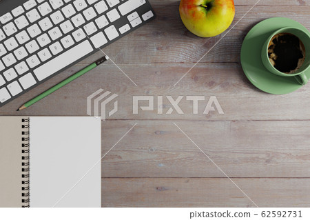 Workspace desk with notebook, keyboard and green 62592731