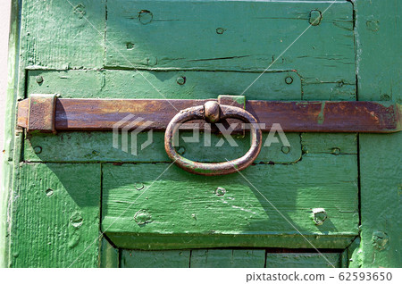 Green wooden door with iron rusty latch Green wooden door with iron rusty latch 62593650
