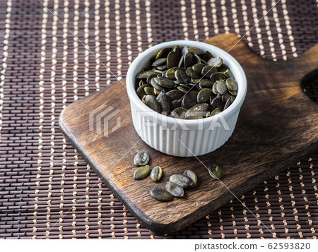 Pumpkin seeds. Vegan protein source. Healthy snack Pumpkin seeds. Vegan protein source. Healthy snack 62593820