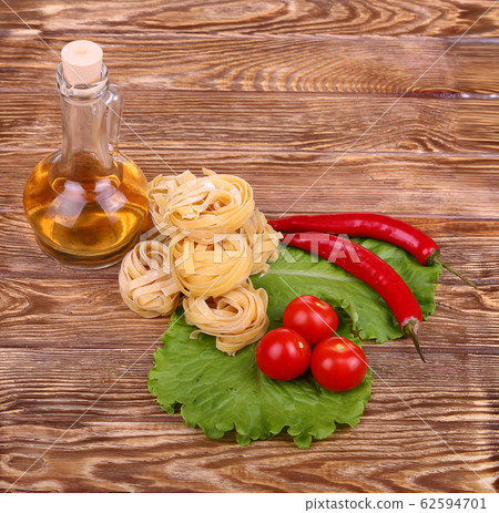 Pasta on the wooden background with tomato, Pasta on the wooden background with tomato, 62594701