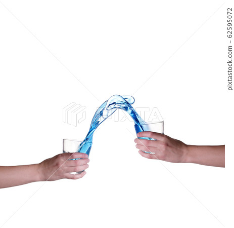 Blue water splashing in glass held by hand, white Blue water splashing in glass held by hand, white 62595072