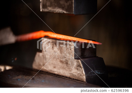 Blacksmith machine for forging a deta il out of the hot metal Blacksmith machine for forging a deta il out of the hot metal 62596396
