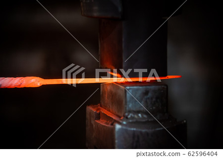 Forging a detail out of the hot metal 62596404