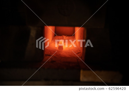 Hot piece of iron lies in the furnace Hot piece of iron lies in the furnace 62596420