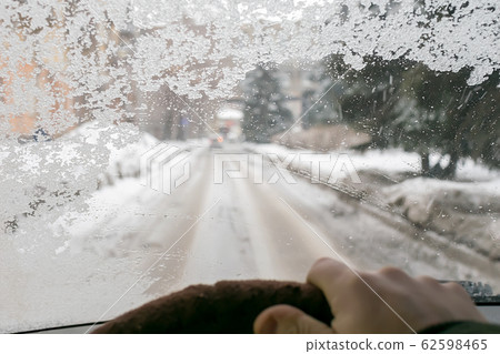 view of the fogged icy cold windshield of the car view of the fogged icy cold windshield of the car 62598465