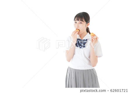 Female students in uniforms eating snacks 62601721