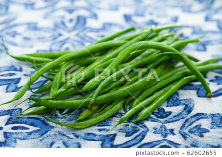 Green beans on blue and white background. Close up. Green beans on blue and white background. Close up. 62602655