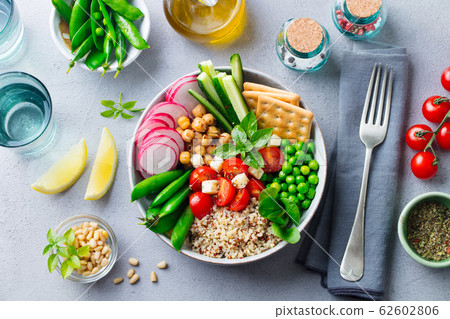 Healthy vegetarian salad. Buddha bowl. Grey stone background. Top view. 62602806