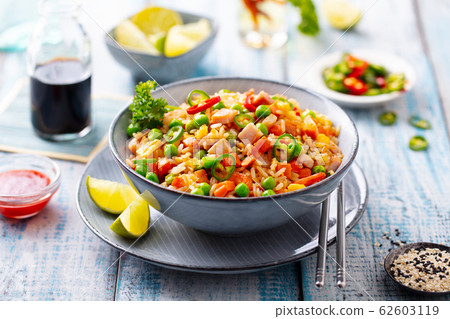 Asian fried rice. Blue wooden background. Close up. 62603119