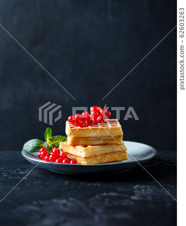 Belgian waffles with fresh red currant berries. Dark slate background. Copy space. 62603263