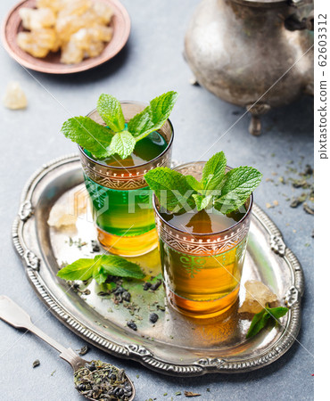 Mint tea, Moroccan traditional drink in glass. Close up. 62603312
