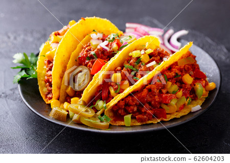 Taco with beef, Mexican traditional cuisine. Dark background. Close up. 62604203