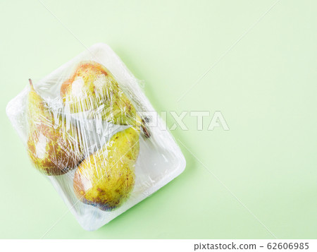 Fresh produce wrapped in plastic film. 62606985