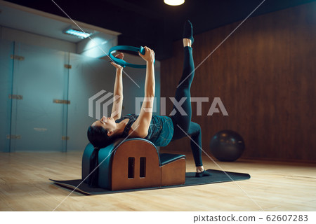 Slim girl on pilates training in gym, flexibility Slim girl on pilates training in gym, flexibility 62607283