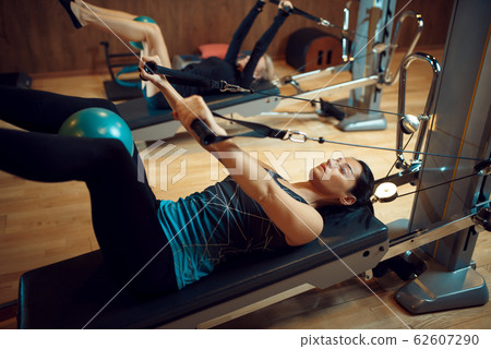 Pilates training with balls on exercise machines Pilates training with balls on exercise machines 62607290