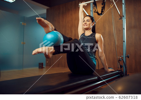 Slim woman, pilates training with ball in gym 62607318