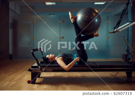 Girl in sportswear, pilates training with ball 62607319