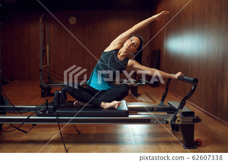 Fit girl in sportswear, pilates training in gym 62607338