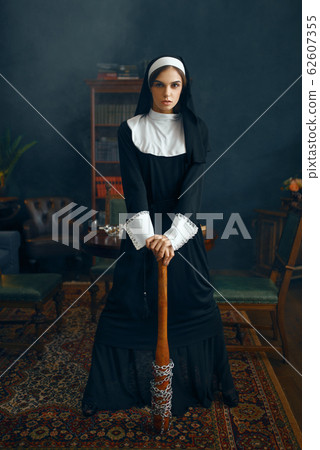 Nun in cassock holds baseball bat wrapped in chain 62607355