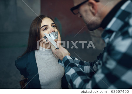Maniac kidnapper taping his victim's mouth shut 62607400
