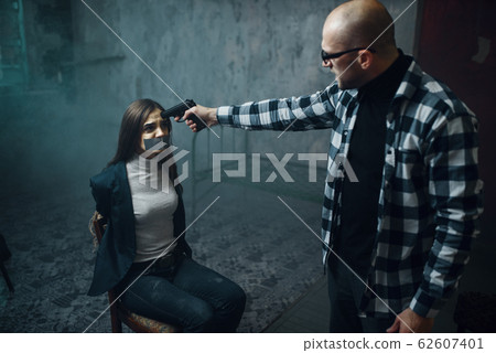 Maniac kidnapper puts a gun to his victim's head Maniac kidnapper puts a gun to his victim's head 62607401