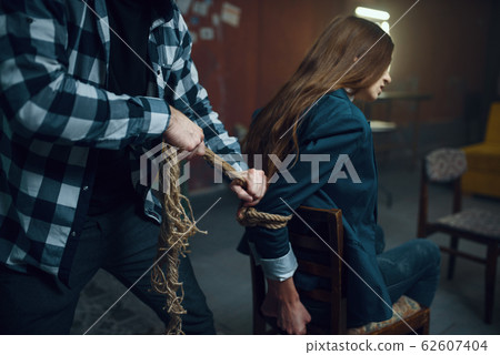 Maniac kidnapper ties his female victim with rope 62607404
