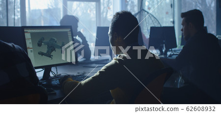 Digital artist working on 3d graphics 62608932