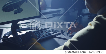 Digital artist working on 3d graphics Digital artist working on 3d graphics 62608933